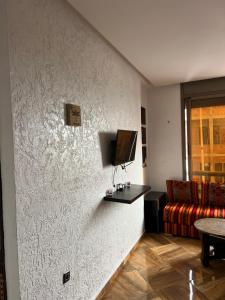a living room with a wall with a tv on it at Guest house in Imsouane
