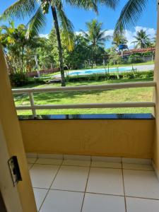 a room with a window with a view of a pool at Pousada Elshadai in Uruçuca +9 photos