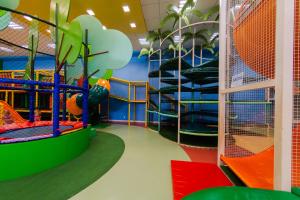 a childrens play area with slides and swings at Tauá Hotel & Convention Atibaia in Bairro Rio Abaixo