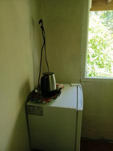 a tea kettle sitting on top of a refrigerator at Cocoa Cabana in Scarborough