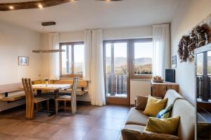 a living room with a couch and a table and chairs at Dissertorihof in Caldaro