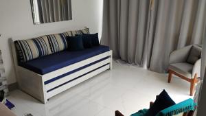 a room with a couch and a chair in it at Villa do Condado in Saquarema