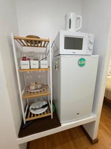 a small refrigerator with a microwave on top of it at Panorama Bungalow in Tahaa