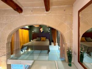 a bedroom with a bed and a glass floor at Dar Divinus - Eat, Wine, Sleep in Rabat