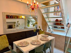 a dining room with a table with plates on it at Dar Divinus - Eat, Wine, Sleep in Rabat