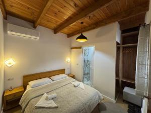 a bedroom with a bed with two towels on it at Bujtina Carku in Theth