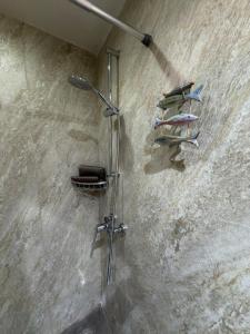 a shower in a bathroom with a rack of towels at Dar Divinus - Eat, Wine, Sleep in Rabat +14 photos