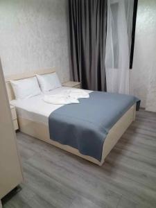 a bed with white sheets and pillows in a room at Kobuleti hotel 656 in Kobuleti