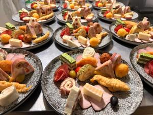 a bunch of plates of food on a table at Pensiunea Vila Maria in Crăcăoani