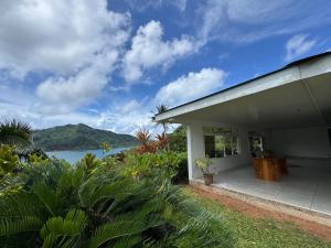 a white house with a view of the water at Grand Panorama Villa in Tahaa