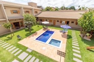 an aerial view of a house with a swimming pool at Pousada das Bandeiras in Olímpia