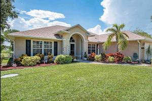 a house with a palm tree in a yard at Sebastian Serenity in Sebastian