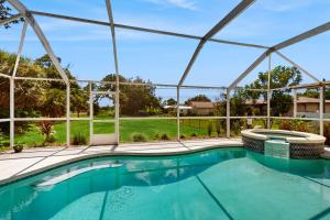 a large swimming pool in a house with a roof at Sebastian Serenity in Sebastian