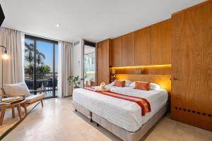 a bedroom with a large bed and a balcony at Zantamar - Beachfront Suites in La Cruz in Cruz de Huanacaxtle +156 photos