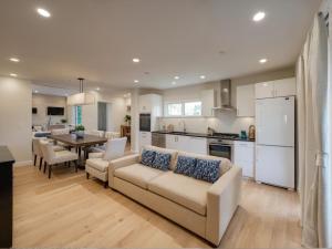 a living room and kitchen with a couch and a table at Stylish 2, 3 and 5 Bedroom Entire Homes Near Art Deco and LA Hotspots in Los Angeles