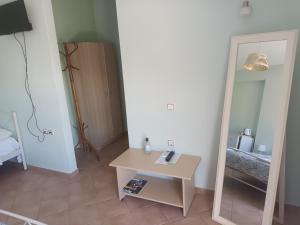 a room with a small table and a mirror at Olympic View Guesthouse in Kalami +40 photos