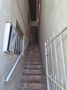 a staircase leading up to a building with a fence at Flat Serrano in Miguel Pereira