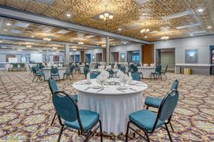 a conference room with tables and chairs and a stage at SureStay Plus Hotel by Best Western Reno Airport in Reno +59 photos