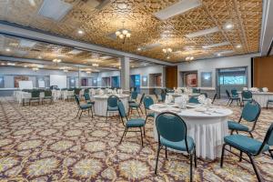 a ballroom with tables and chairs and a banquet facility at SureStay Plus Hotel by Best Western Reno Airport in Reno