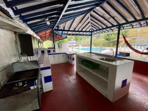 a large kitchen with a view of a pool at Finca La Piscina in Viterbo