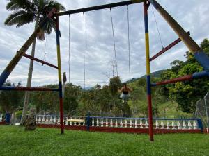 a man is jumping on a swing at Finca La Piscina in Viterbo