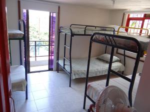 a room with three bunk beds and a balcony at Finca La Piscina in Viterbo