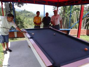 a group of men standing around a pool table at Finca La Piscina in Viterbo