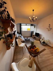 a living room with a table with a bowl of fruit at Apartment Fortuna in Korčula