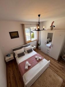 a bedroom with a large bed with towels on it at Apartment Fortuna in Korčula