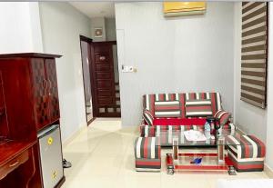 a living room with a chair and a table at Stargazer Hotel in Danang