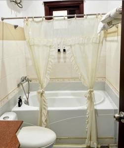 a bathroom with a white tub and a toilet at Stargazer Hotel in Danang +36 photos