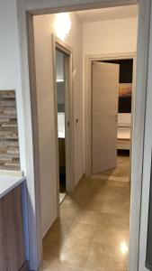 a hallway with a door leading to a bedroom at Near Sea in Monopoli
