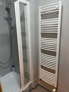 a walk in shower with a mirror in a bathroom at Nido in the center in Poprad