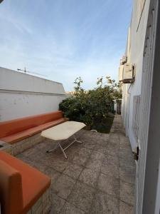 a bench sitting on a sidewalk next to a building at Duplex raffiné avec entrée privée in Tunis