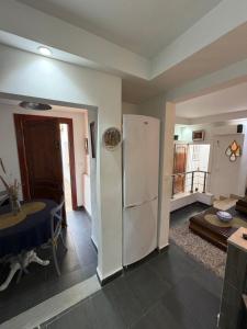 a living room with a refrigerator and a table at Duplex raffiné avec entrée privée in Tunis +8 photos