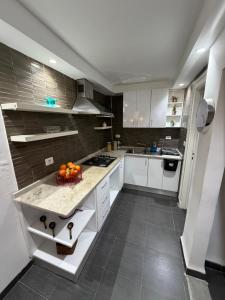 a kitchen with a bowl of oranges on a counter at Duplex raffiné avec entrée privée in Tunis