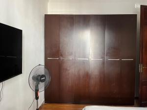 a bedroom with a brown closet and a fan at Casa en Pocitos in Montevideo +2 photos