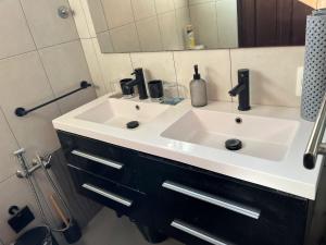 a bathroom with a white sink and a mirror at Casa en Pocitos in Montevideo