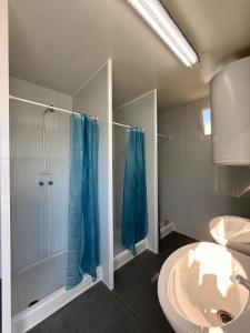 a bathroom with a shower and a sink at Romantic Sailboat Retreat Marina de Alcantara Downtown Lisbon in Lisbon