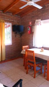 a dining room with a table and two chairs at Cabañas Llajta Sumaj in Las Calles