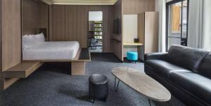 a hotel room with a bed and a couch at Hotel Shocard Broadway, Times Square in New York +22 photos