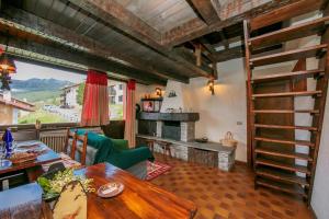 a living room with a table and a fireplace at Arianna - Happy Rentals in Livigno