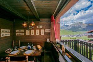 a balcony with a table and a view of a mountain at Arianna - Happy Rentals in Livigno