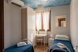 a room with two beds and a table with a mirror at B&B LA PALMA in Ravarino