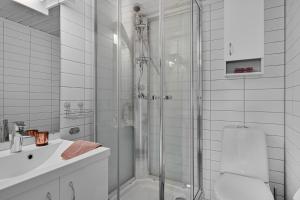a white bathroom with a shower and a sink at Deluxe Room! in Lucan