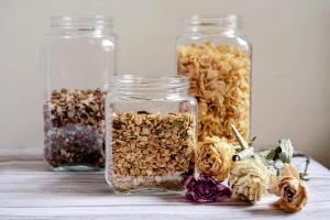 three jars of granola and dried flowers on a table at Deluxe Room! in Lucan