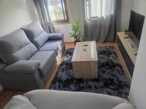 a living room with a couch and a coffee table at Casa de sney in Sarria