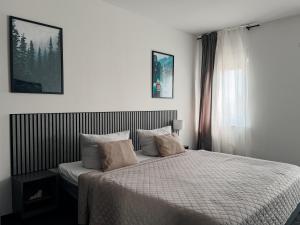 a bedroom with a bed and a window at MiDaMi 24h Hotel Self-Checkin in Schwanau +22 photos