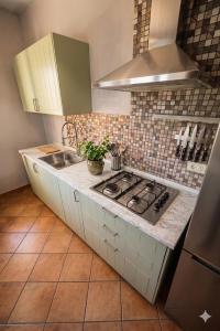 a kitchen with a sink and a stove top oven at B&B LA PALMA in Ravarino