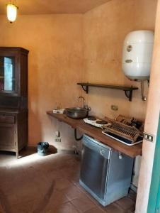 a kitchen with a counter with a sink and a stove at Chalet besides sakkara piramid in Cairo